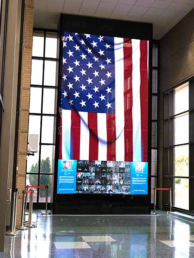 The digital memorial wall located inside the main entrance to the USASOC Headquarters serves as a living, interactive tribute to the ARSOF Fallen of the post-9/11 era.