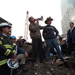 President George W. Bush addresses first responders at the site of the collapsed World Trade Center buildings, just days after the 9-11 attacks.