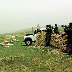 Special Forces soldiers observe the Iraqi village of Ayn Sifni in April 2003.