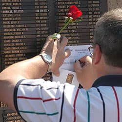 A Gold Star parent etches the name of his loved one from the USASOC Memorial Wall, Fort Bragg, North Carolina, 2007.