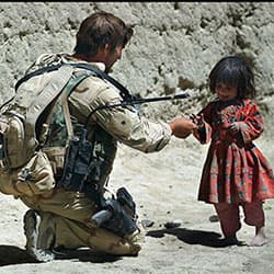 A Special Forces soldier builds rapport with a local Afghan child, 2007.