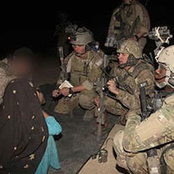 Psychological Operations, Civil Affairs, and Cultural Support Team members question an Afghan female through an interpreter during a Special Operations mission in Afghanistan, 2011. 