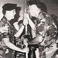 Colonel John N. Dailey accepts the 617th guidon from Major (MAJ) Kenneth J. Himmerlick, and prepares to pass it to the new company commander, MAJ Richard D. Compton, in July 1989.