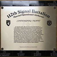 The inscription on the base of the 112th Signal Battalion Commander’s Trophy describes the situation at the time it was damaged. The names of Company Commander and First Sergeant from each year’s winning company line the top and bottom of the base.