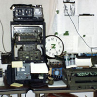 In David, Panama, the SOCA team supporting Operational Detachment Alpha 773 operated out of the local police headquarters. The SOCA set-up pictured here included TTY-76 teletype, AN/PCS-3 UHF satellite communications radio, AN/PRC-70 FM radio, various encryption devices, a power supply, data modem, and portable generator. The team’s facsimile (fax) machine is located between the two racks. (Photo Courtesy of William D. Childs)