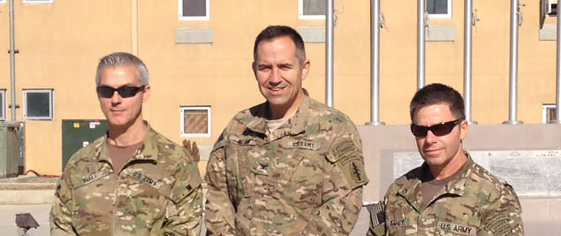 The last CJSOTF-A command group commemorates the unit deactivation on 31 October 2014 with a photo in front of the CJSOTF-A Memorial Wall, Camp Vance, Bagram Airbase. From left to right are: CW5 Edward K. Hall, COL Robert L. Wilson, and CSM Brian C. Rarey.