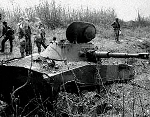 1st Cavalry Division troops gawk at knocked out PT-76 tank at Lang Vei in May 1968.