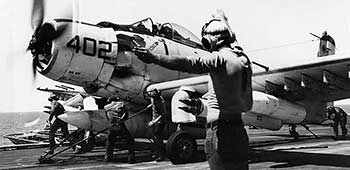 A heavily armed A-1J Skyraider (VA-25) ready to launch from the U.S.S. Coral Sea.