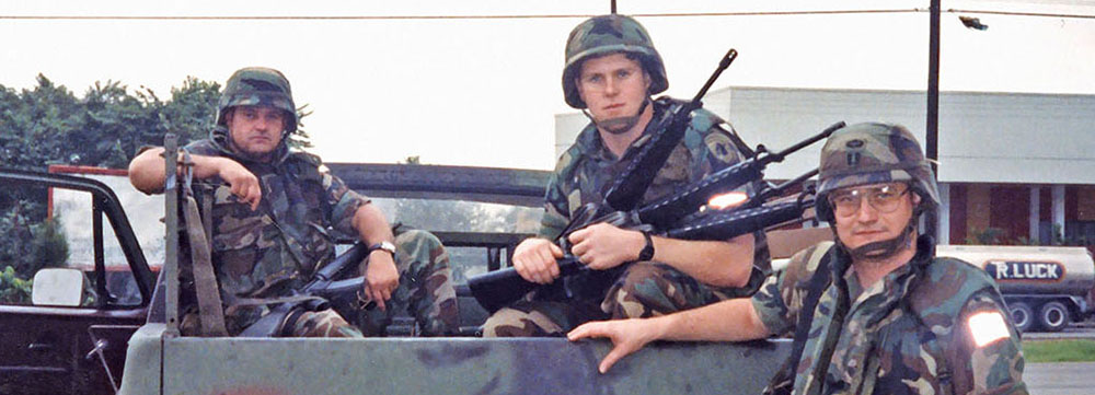 SFC James Boone, Sergeant (SGT), Stephen R. Anderson, and CPT Mark A. Olinger with their M1008 Commercial Utility Cargo Vehicle (CUCV). SGT Anderson shows off captured Panamanian M-16 rifles that had been cached by forces loyal to General Manuel Noriega. Notice the markings on the tailgate of the CUCV. 