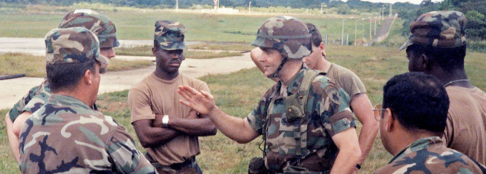 528th Commander, Lieutenant Colonel David L. Shaw, meets the FARP team at Howard Air Force Base in late December, 1989. Staff Sergeant Sammie L. Mitchell (center-left), the team’s leader, listens intently.