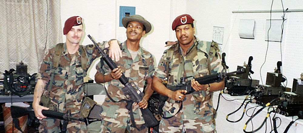 Sergeant (SGT) William D. Childs, Staff Sergeant (SSG) Henry N. McCrae, and SGT Darell A. Brown pose in the SOCSOUTH radio room at Albrook Air Station in January 1990.
