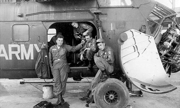 11th Aviation Company aircraft mechanics pose by an H-34.