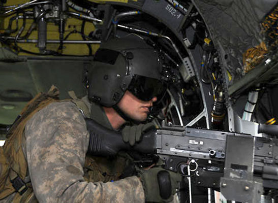 An MH-47G Chinook crew chief scans his sector during training.  Capable, motivated helicopter repairers assigned to 160th maintenance companies can train to become NRCMs through Company B, SOATB.