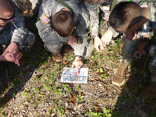 Soldiers attempt to find their location on a map during the Land Navigation phase of the Combat Skills course (Company A, SOATB). 