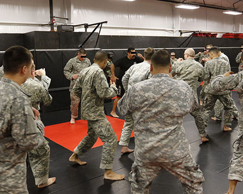 A ‘Black Shirt’ instructor teaches students combatives techniques during Combat Skills.  