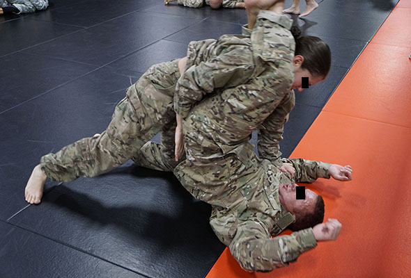 Two officers grapple during the Combatives phase of Combat Skills, Company A, SOATB.