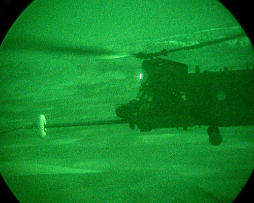 An MH-47 conducts HAAR at night.  To prepare for their real-world 160th SOAR missions, aviation students attending their BMQ courses in Company B, SOATB, must achieve proficiency in the use of Night-Vision Goggles (NVGs).