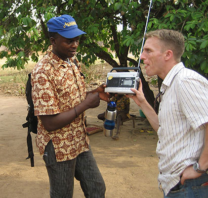 Jason Lewis-Berry, State Department counter-LRA advisor, tests radio reception with a local near Dungu, Democratic Republic of the Congo.