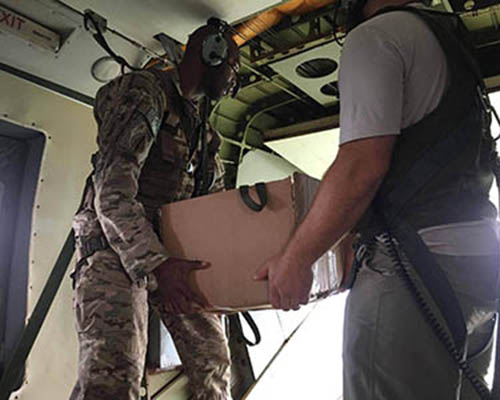 U.S. soldiers prepare to release a leaflet-laden box over a suspected LRA location.