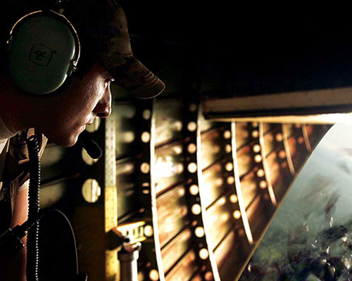 U.S. soldiers release leaflets over a suspected LRA location.