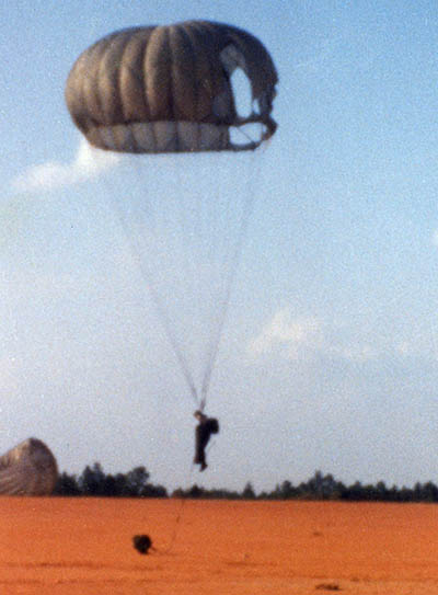 A SOSB soldier prepares to execute a parachute landing fall during a combat equipment airborne operation on Fort Bragg, NC.