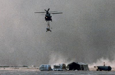 The lead Chinook attempts to set the Hind down at N’Djamena prior to being overtaken by the sandstorm. The wall of sand rose more than 3,000 feet into the air.
