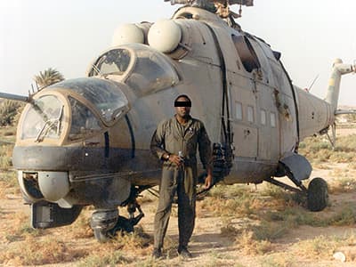 The Hind at Faya Largeau with SSG Oscar Waters in front. This photo shows how the helicopter was rigged for sling load.