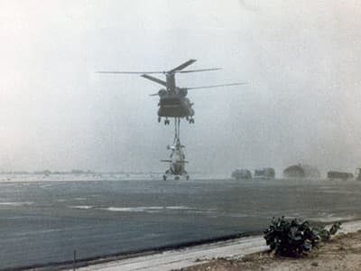 MAJ Hasselbach sets the Hind down on the tarmac at N’Djamena as the sand storm swallows hangars at the far end of the field. As soon as the Hind was released, the Chinook landed alongside.