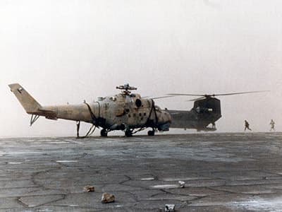 The Hind with MAJ Hasselbach’s Chinook just as the sand storm is about to engulf them. The Chinook’s rotor blades are still turning as the crews could not shut the engines off for fear that the wind might bend the blades into the airframe.