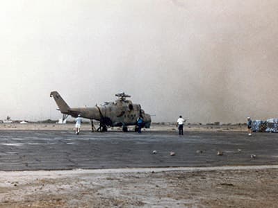 The Hind at N’Djamena after the sand storm. Civilian personnel have already begun securing the airframe for transport to the United States.