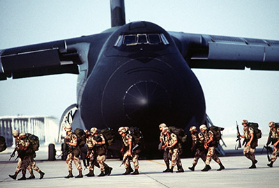 The C-5, seen here offloading troops in Saudi Arabia, was the largest cargo aircraft in the USAF inventory.