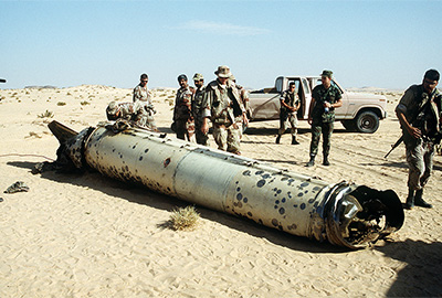 Military personnel examine a Scud missile shot down in the desert by an MIM-104 Patriot tactical air defense missile during Operation DESERT STORM.