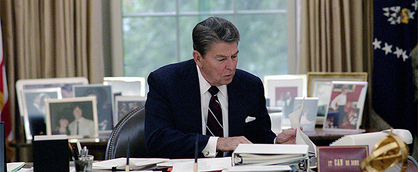 President Ronald W. Reagan works in the Oval Office, 31 May 1985.