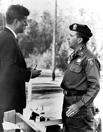 Brigadier General William P. Yarborough, U.S. Army Special Warfare Center Commander, met with President John F. Kennedy during the President’s October 12, 1961, visit to Fort Bragg, NC. This moment inspired the statue of the two men that currently stands outside Kennedy Hall on the USAJFKSWCS campus. 