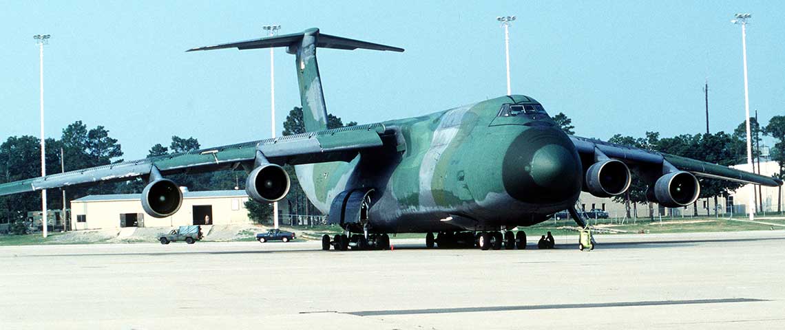 A C-5A Galaxy aircraft stands ready on the flight line at Pope Air Force Base, NC, during Operation DESERT SHIELD. PSYOP units had to compete with combat units for seats on airframes destined for Saudi Arabia, causing soldiers to arrive piecemeal.