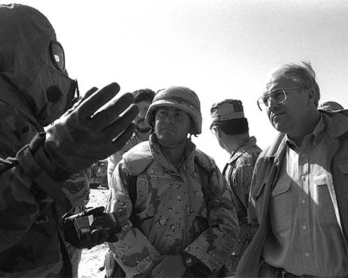 Concerns about Nuclear, Chemical, and Biological (NBC) attacks by Iraqi forces prompted the U.S. military to prioritize NBC countermeasures. Here a U.S. servicemember demonstrates Mission-Oriented Protective Posture level 4 (MOPP-4) to visiting Secretary of Defense Richard B. Cheney in December 1990, during Operation DESERT SHIELD. MOPP equipment and proficiency were required of deployed forces, including reservists.