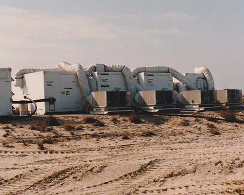 Row of S-280 shelters comprising the AN/TRT-22 system at Abu Ali. Note the HVAC cooling units behind them.