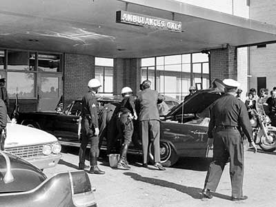 Police and onlookers outside of Parkland Memorial Hospital, shortly after the arrival of the mortally wounded JFK. He was pronounced deceased at 1300 hours local, with the nation getting the news about a half hour later.
