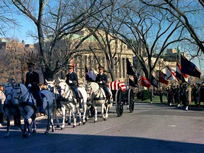 Drawn by six gray horses, the caisson moves from the White House to St. Matthew's Cathedral, 25 November.