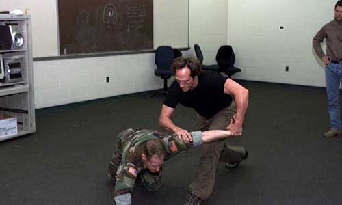 Fichtner executes an arm and wrist lock during combatives training with 7th SFG.