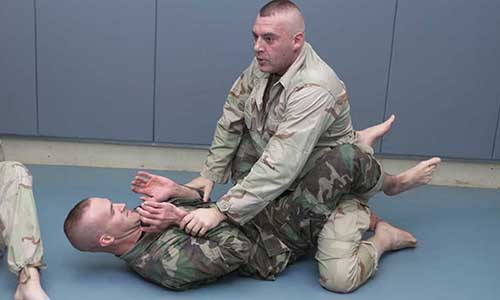 Actor Tom Sizemore works on closed guard escapes during hand-to-hand fighting training with the Rangers.