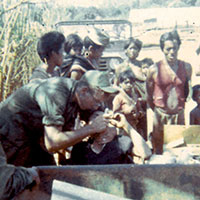 SP5 Jerry Bisco of Team 15 provides dental care for villagers near Pleiku. Such medical care, to include treating residents at a local leper colony, was often the first modern medicine to which the villagers ever had access.