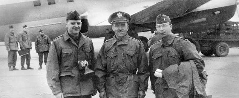 1LTs Robert H. Barnaby (left) and Robert M. Zweck (right) pose with CPT Victor U. Tervola, 1st RB&L, just before boarding chartered commercial aircraft destined for the East Coast.
