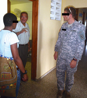PFC Anastasia Anse (left) interprets as SSG Dave Ost (right) consults with Dr. Bordeau (middle), who made sure that the child was promptly admitted to the HHF Klinik Pep Bondye-a facility in Jérémie.