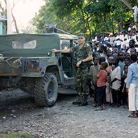 CPT Martin C. Schulz stands among Haitians