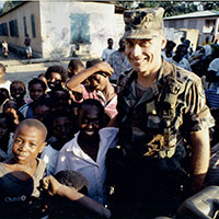 CPT Martin C. Schulz poses with Haitian children