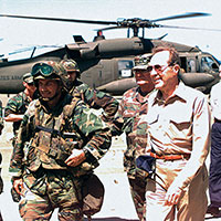 Secretary of Defense William J. Perry (center, in khakis)