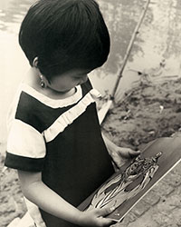 A young girl admires her ‘Year of the Tiger’ Giap Dan (1974) calendar/notebook