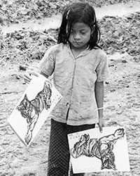 A young girl holding copies of ‘Year of the Tiger’ Giap Dan (1974) calendar/notebook