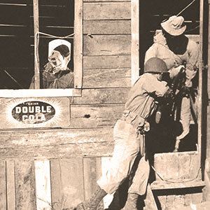 SGT Joe Perna (Ranger student) bayonets a dummy as part of the ‘mopping up’ of ‘Naziville.’ Note the caricature of Adolf Hitler in the window.